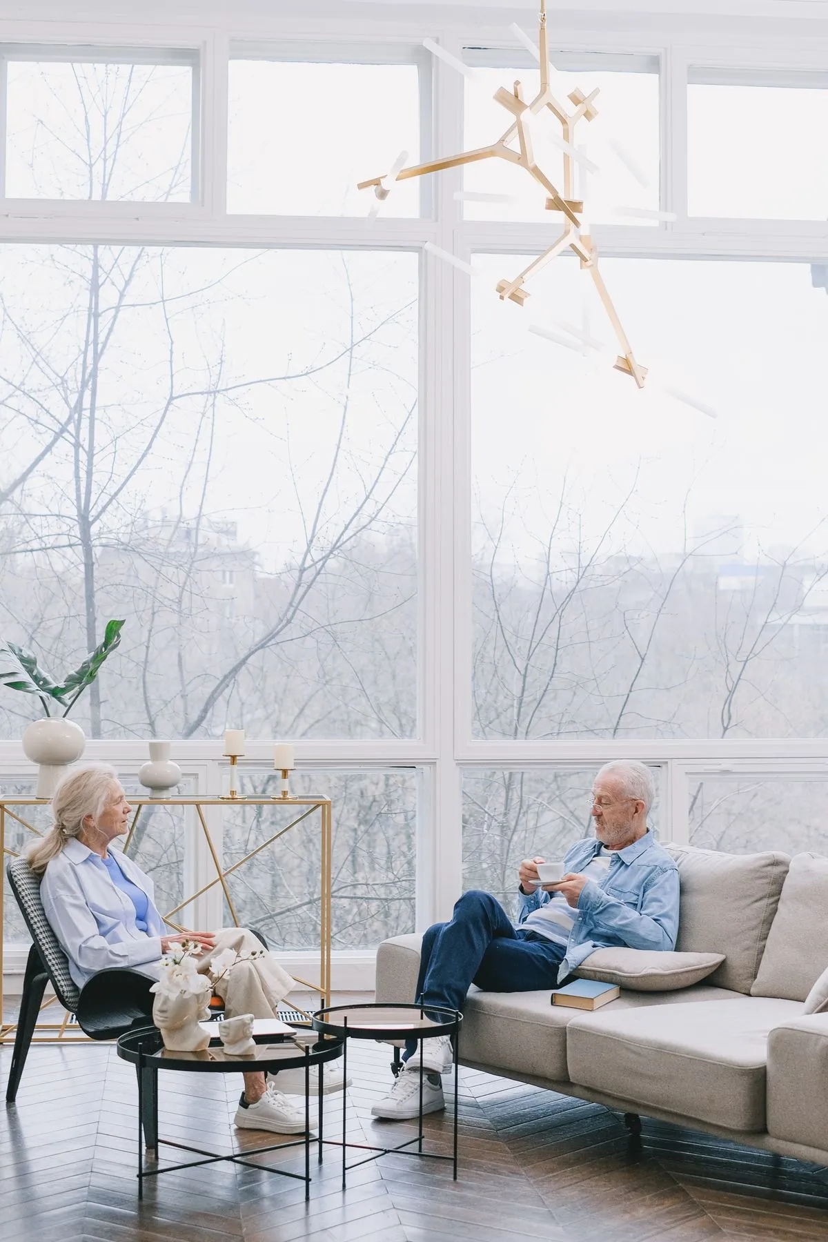 A retired couple relaxing together in a bright living room